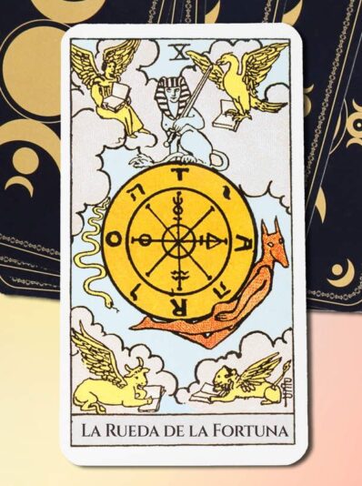 Tarot cards, peacock feathers, gemstones and old book on wooden table, top view with space for text. Reverse side